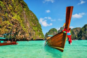 A boat near a coral island, floating on crystal clear, blue'ish water